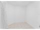 A small walk-in closet with off-white tile and shelving at 15123 Bald Eagle St, Tampa, FL 33625