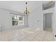Bright dining room with tile flooring, chandelier, and a large window offering plenty of natural light at 15123 Bald Eagle St, Tampa, FL 33625