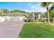 Charming single-story home with a brick driveway, well-manicured lawn, and tropical landscaping at 15123 Bald Eagle St, Tampa, FL 33625