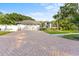 Beautiful single-story home featuring a brick driveway, lush landscaping, and a well-maintained lawn at 15123 Bald Eagle St, Tampa, FL 33625
