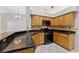 Eat-in kitchen featuring granite countertops, tile backsplash, and updated black appliances at 15123 Bald Eagle St, Tampa, FL 33625
