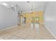 Large living room featuring tile flooring, neutral paint, ceiling fans, and an open layout to other living spaces at 15123 Bald Eagle St, Tampa, FL 33625