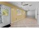 Living room with tile floors, ceiling fans, and multiple windows for natural light at 15123 Bald Eagle St, Tampa, FL 33625