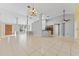 Open-concept living room featuring tile flooring, columns, and elegant chandelier lighting at 15123 Bald Eagle St, Tampa, FL 33625
