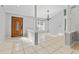 Open living room with neutral paint, tile floors, chandelier, and large windows offering natural light at 15123 Bald Eagle St, Tampa, FL 33625