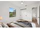 Staged bedroom showcasing natural light, hardwood floors, and a large window view at 15218 Appleton Blvd, Port Charlotte, FL 33981