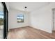 Bright bedroom featuring hardwood floors, a modern light fixture and access to outdoor living at 15218 Appleton Blvd, Port Charlotte, FL 33981