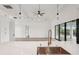Bright, open kitchen boasts an island with a copper faucet and sink, as well as modern pendant lighting at 15218 Appleton Blvd, Port Charlotte, FL 33981