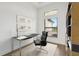 This staged office has modern furnishings and features a large window for lots of natural light at 15218 Appleton Blvd, Port Charlotte, FL 33981