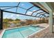 Inviting screened-in pool and spa overlooking a serene waterfront view at 15218 Appleton Blvd, Port Charlotte, FL 33981