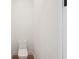 A minimalist powder room features a modern toilet and clean white walls at 15218 Appleton Blvd, Port Charlotte, FL 33981