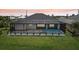 Charming rear exterior of the property with screened lanai and pool at 15218 Appleton Blvd, Port Charlotte, FL 33981