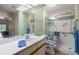 Bright bathroom featuring a shower with grab bars, a toilet, and a vanity with a sink for convenience at 1709 Castle Rock Rd, Tampa, FL 33612