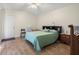 Cozy bedroom with light-colored walls, wood-look flooring, and a ceiling fan for added comfort at 1709 Castle Rock Rd, Tampa, FL 33612
