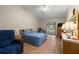 Relaxing bedroom with wood-look flooring, a ceiling fan, and a sliding glass door to a screened-in porch at 1709 Castle Rock Rd, Tampa, FL 33612