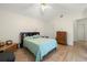 Comfortable bedroom featuring wood-look flooring, neutral walls, and a ceiling fan for optimal air circulation at 1709 Castle Rock Rd, Tampa, FL 33612
