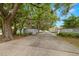Sutton Place entrance featuring mature trees, signage, and well-maintained landscaping at 1709 Castle Rock Rd, Tampa, FL 33612