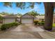 Charming home featuring a large garage, well-maintained landscaping, and a welcoming driveway at 1709 Castle Rock Rd, Tampa, FL 33612
