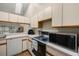 Well-lit kitchen featuring essential appliances, light countertops, and ample cabinet space at 1709 Castle Rock Rd, Tampa, FL 33612