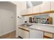Practical kitchen layout featuring a breakfast bar, light countertops, and white cabinetry at 1709 Castle Rock Rd, Tampa, FL 33612