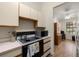 Functional kitchen with a cooktop stove, light cabinets, and easy access to the adjacent room at 1709 Castle Rock Rd, Tampa, FL 33612