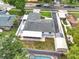 Aerial view of a backyard, pool, shed and a home with long drive and carport surrounded by neighboring houses at 17824 Morninghigh Dr, Lutz, FL 33549