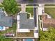 Bird's eye view of a backyard, pool, shed and a home with long drive and carport surrounded by neighboring houses at 17824 Morninghigh Dr, Lutz, FL 33549