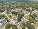 Wide aerial shot of a neighborhood, showcasing the home's ideal location amid mature trees and well-maintained properties at 17824 Morninghigh Dr, Lutz, FL 33549