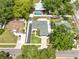 An aerial view of a home nestled among verdant trees, showcasing its inviting yard and cozy neighborhood surroundings at 17824 Morninghigh Dr, Lutz, FL 33549
