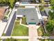 Aerial view of a charming home with a lush backyard, carport, and long driveway in a quiet neighborhood at 17824 Morninghigh Dr, Lutz, FL 33549