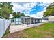 Spacious backyard featuring a brick patio and privacy fence at 17824 Morninghigh Dr, Lutz, FL 33549