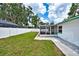 The home's backyard with a grassy lawn and a white privacy fence at 17824 Morninghigh Dr, Lutz, FL 33549