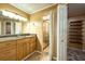 The primary bath boasts a granite vanity, framed mirror, tile floor, and a glass enclosed shower at 17824 Morninghigh Dr, Lutz, FL 33549
