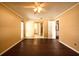 A cozy bedroom features hardwood floors, a ceiling fan, and plenty of natural light at 17824 Morninghigh Dr, Lutz, FL 33549