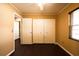 A comfortable bedroom includes hardwood floors, a window, and a closet with double doors at 17824 Morninghigh Dr, Lutz, FL 33549