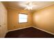 A cozy bedroom features hardwood floors, a ceiling fan, and a bright window at 17824 Morninghigh Dr, Lutz, FL 33549