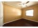 Cozy bedroom features a ceiling fan, window, and hardwood floors at 17824 Morninghigh Dr, Lutz, FL 33549