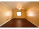 A bright bedroom includes hardwood floors, a ceiling fan, and a window for natural lighting at 17824 Morninghigh Dr, Lutz, FL 33549