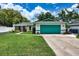 Charming single-story home featuring a lush lawn, attached two-car garage and neatly manicured landscaping at 17824 Morninghigh Dr, Lutz, FL 33549