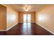 A spacious living room features a ceiling fan and sliding glass doors to the enclosed patio at 17824 Morninghigh Dr, Lutz, FL 33549
