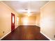 Inviting living room featuring hardwood floors, ceiling fan and a red front door at 17824 Morninghigh Dr, Lutz, FL 33549