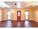 Spacious living room with hardwood floors, a ceiling fan, and natural light from the windows at 17824 Morninghigh Dr, Lutz, FL 33549