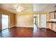 A spacious living room includes a ceiling fan, hard wood floors, and a view of the kitchen at 17824 Morninghigh Dr, Lutz, FL 33549