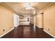 An open-concept living room provides hardwood floors, ceiling fan, and access to the kitchen at 17824 Morninghigh Dr, Lutz, FL 33549
