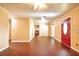 Bright living room with hardwood floors, ceiling fan and a red front door at 17824 Morninghigh Dr, Lutz, FL 33549
