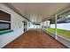 The covered patio has brick flooring and leads to the backyard at 17824 Morninghigh Dr, Lutz, FL 33549