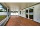 Outdoor patio features brick flooring and access to backyard at 17824 Morninghigh Dr, Lutz, FL 33549