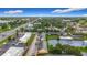 Aerial view of the apartments, parking lot, swimming pool, pond and surrounding community with beautiful landscape at 200 Country Club Dr # 202, Largo, FL 33771