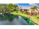 Exterior view of apartments with a beautiful landscape and a pond at 200 Country Club Dr # 202, Largo, FL 33771