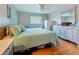 Bedroom with hardwood floors, ceiling fan, and plenty of natural light at 200 Country Club Dr # 202, Largo, FL 33771